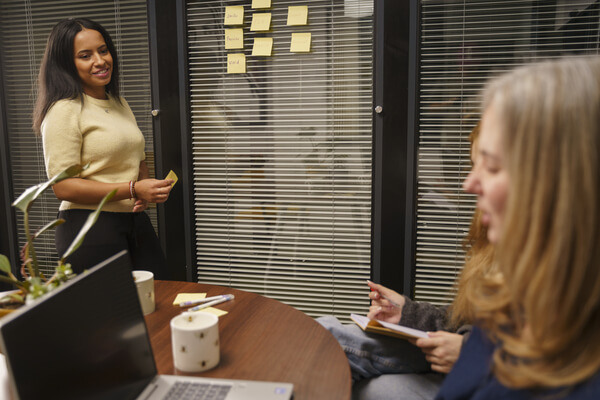 PolicyBee's Chantelle making plans using post-it notes