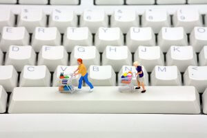 Miniature people pushing trolleys on a keyboard_Image used under license from Shutterstock Miniature people pushing trolleys on a keyboard_Image used under license from Shutterstock