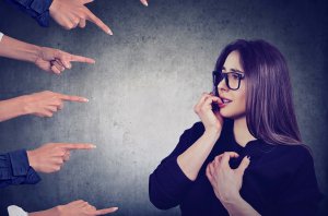 Anxious woman accused by different people_image used under license from Shutterstock Anxious woman accused by different people_image used under license from Shutterstock