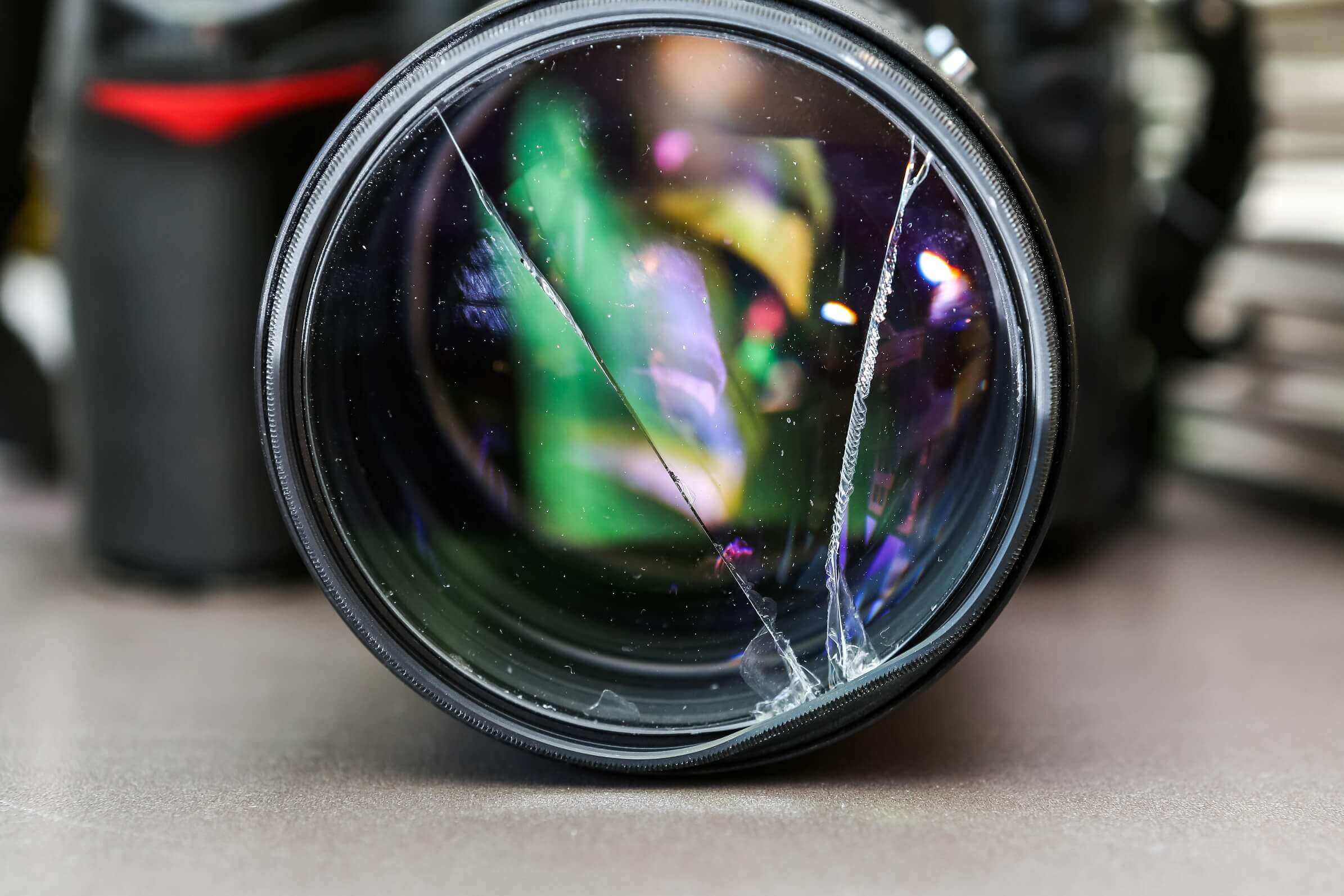 Broken DSLR camera lens filter glass_shutterstock_225545701 - PolicyBee